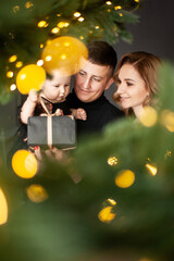 Fototapeta na wymiar Family portrait. Christmas mood. Dark background