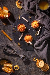 Homemade orange ice cream on a dark background with Ice cream spoon from stainless steel, flat lay, top view