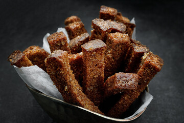 Crackers from dark bread with garlic, on a dark