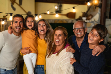 Happy Hispanic family enjoying holidays together at home - 555121567