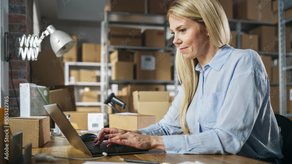 Wall mural happy customer support manager using laptop computer to check order number on a parcel, preparing a 