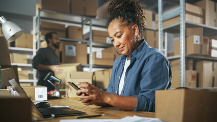 Inventory Manager Using Smartphone to Scan a Barcode on Parcel, Preparing a Small Cardboard Box for...