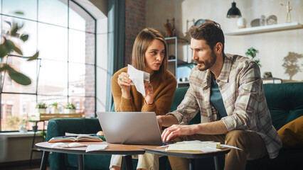 Accounting at Home: Couple Using Laptop Computer, Consulting Eachother in Apartment. Young Family...