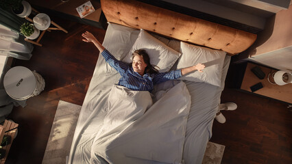 Top View Home: Beautiful Young Woman Sleeps in Her Bed, Sun Shines on Her and She Opens Eyes and...