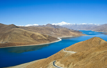  a beautiful blue lake on the highest land with mountains, blue skies, and white clouds.