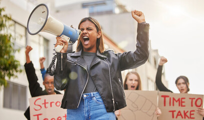 Protest, shouting and woman with megaphone in city marching for gender equality, justice and...