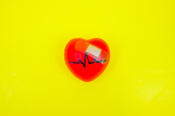 Pulsing heart, heartbeat with Band-Aid symbolise as heart diseases, heart health, unhealthy heart conditions, heart problems, education and heart health awareness risks.