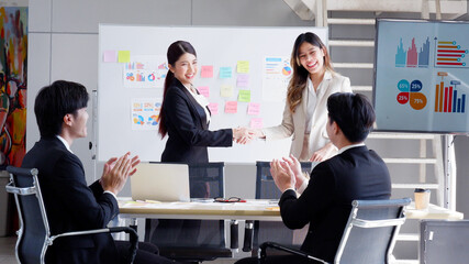 Businesswoman successfully negotiating business with congratulating handshake. Business concept.
