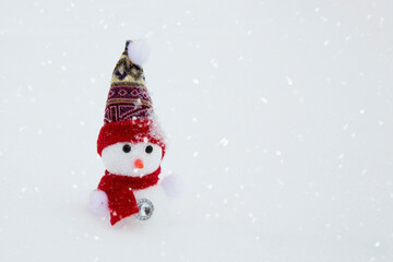 Christmas tree toy snowman on a winter background. 