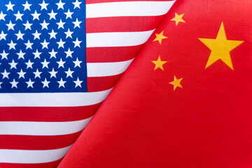 Background of the flags of the USA and China. The concept of interaction or counteraction between...