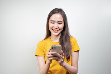 Fototapeta premium Happy Asian woman holding a smartphone and enjoy using app.