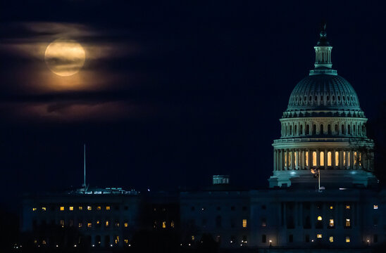 A supermoon seen as it rises behind the U.S. Capitol in Washington DC. Digitally enhanced. The elements of this image furnished by NASA.