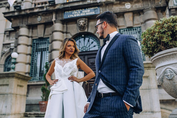 bride and groom in front of city hall