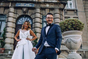 bride and groom in front of city hall