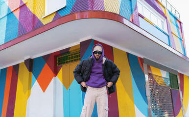 Man standing outside colorful building