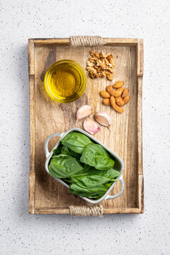 Ingredients for pesto sauce on wooden board