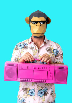 Anonymous guy in monkey mask standing in blue studio with retro boombox
