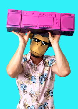 Anonymous guy in monkey mask standing in blue studio with retro boombox