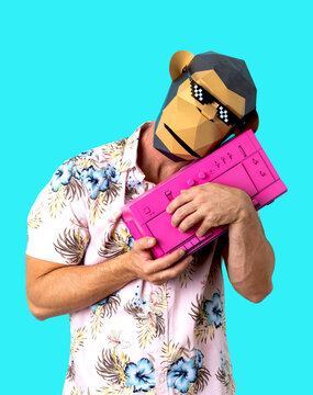 Unrecognizable man in monkey mask embracing vintage tape recorder