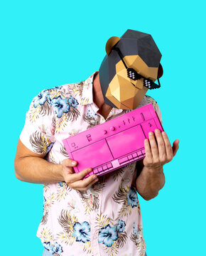 Unrecognizable man in monkey mask embracing vintage tape recorder