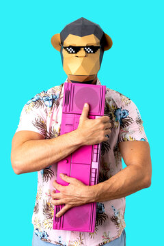 Unrecognizable man in monkey mask embracing vintage tape recorder