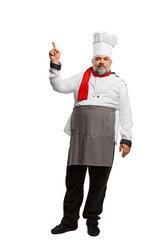 Portrait of bearded man, restaurant chef in uniform posing, pointing isolated on white background. Information