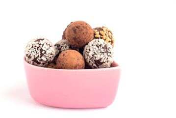 In a pink decorative vase, a set of chocolate delicious sweets, isolated on a white background.