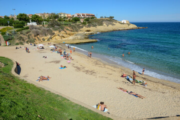 Fototapeta na wymiar People sunbathing on the Beach of Balai at Porto Torres on Sardinia in Italy