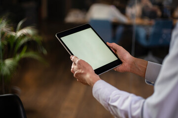 Close up of man using digital tablet.