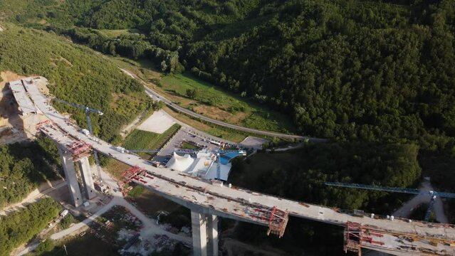 Highway bridge under construction. Aerial view of nes road. Freeway being built on a mountain terrain..