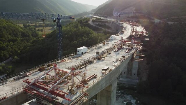 Highway bridge under construction. Aerial view of nes road. Freeway being built on a mountain terrain..