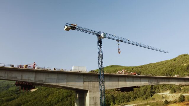 Highway bridge under construction. Aerial view of nes road. Freeway being built on a mountain terrain..