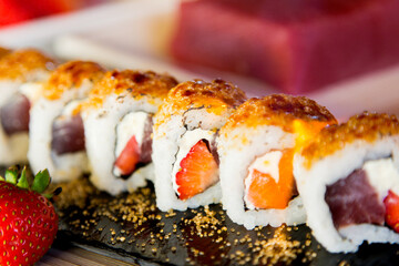 Tuna uramaki with strawberry in Japanese restaurant. 
