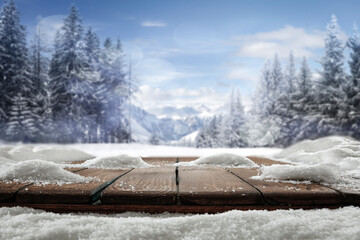 Winter wooden table on a frosty day with snow and free space