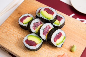 Tuna maki with avocado in Japanese restaurant. Combination of fish and rice covered with seaweed. © Leckerstudio