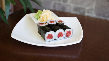 Tuna maki in Japanese restaurant. Combination of fish and rice covered with seaweed.
