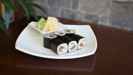 Tuna maki in Japanese restaurant. Combination of fish and rice covered with seaweed.