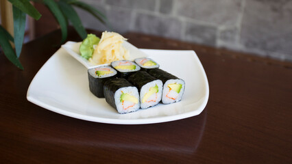 Surimi uramaki sushi roll in a Restaurant in Tokyo.