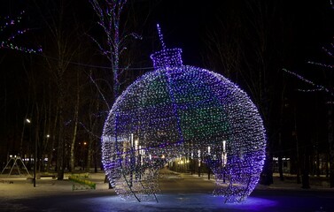 Luminous ball in the form of a Christmas toy in the evening park in Nizhny Novgorod