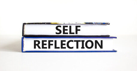 Self reflection symbol. Concept word Self reflection typed on books. Beautiful white table white background. Business psychological and self reflection concept. Copy space.