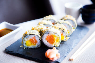 Hot roll fried  Sushi Roll with Salmon and Vegetables. Modern sushi recipe in Japan.