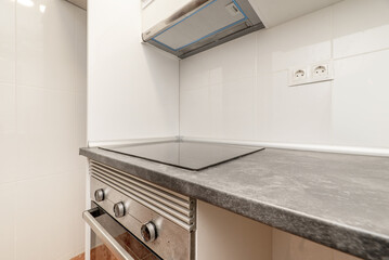 Small kitchen with newly installed white cabinets with gray countertops and stainless steel...