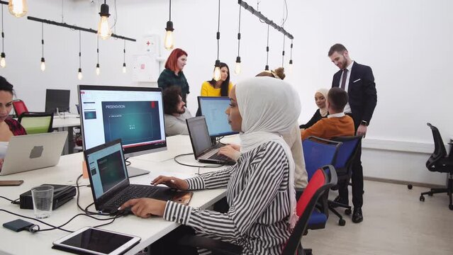 Group of business multicultural people and software developers working as a team in startup coworking office