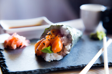 Salmon temaki. Sushi cone filled with rice and salmon. Traditional sushi food in Japan.