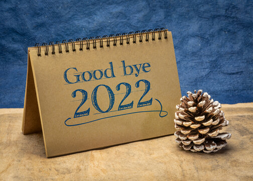 Good bye 2022 - note in a spiral notebook with a frosty decorative cone, passing old year concept