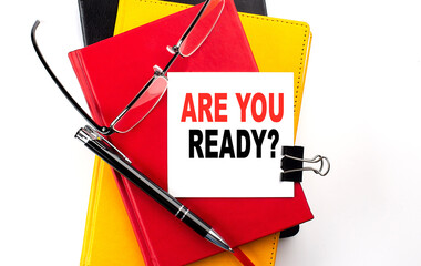 ARE YOU READY text written on a sticky on colorful notebooks