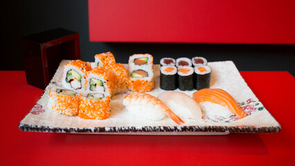Set of sushi with variety of makis, nigiris and sashimi with fine fish like salmon and tuna.