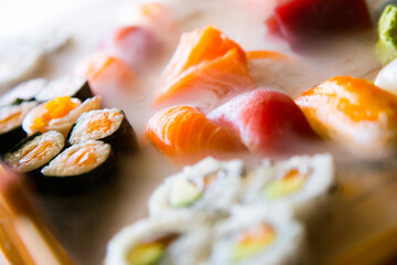 Set of sushi with variety of makis, nigiris and sashimi with fine fish like salmon and tuna.