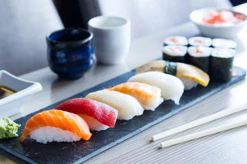 Foto op Plexiglas Set of sushi with variety of makis, nigiris and sashimi with fine fish like salmon and tuna. © Leckerstudio