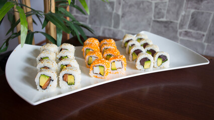 Set of sushi with variety of makis, nigiris and sashimi with fine fish like salmon and tuna.